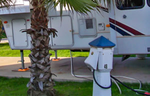 RV attached to energy mate power supply pedestal in tropical RV park
